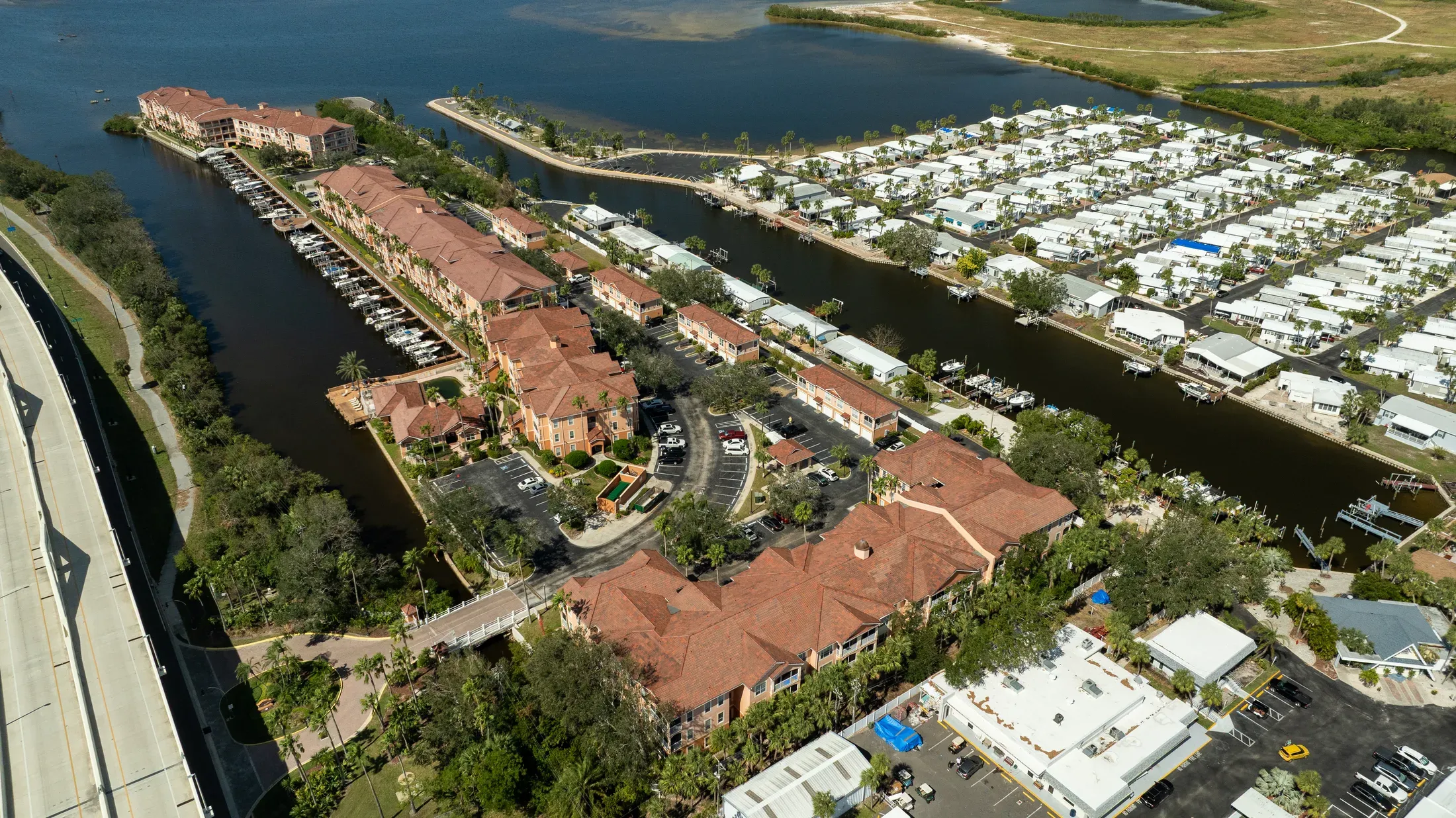 Spanish barrel tile roofing installed across a waterfront residential community