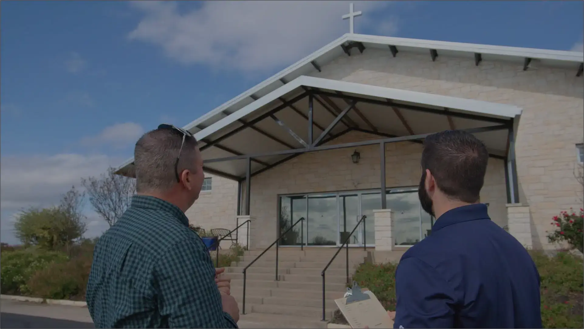Ark consultant reviewing a commercial roof with a property owner