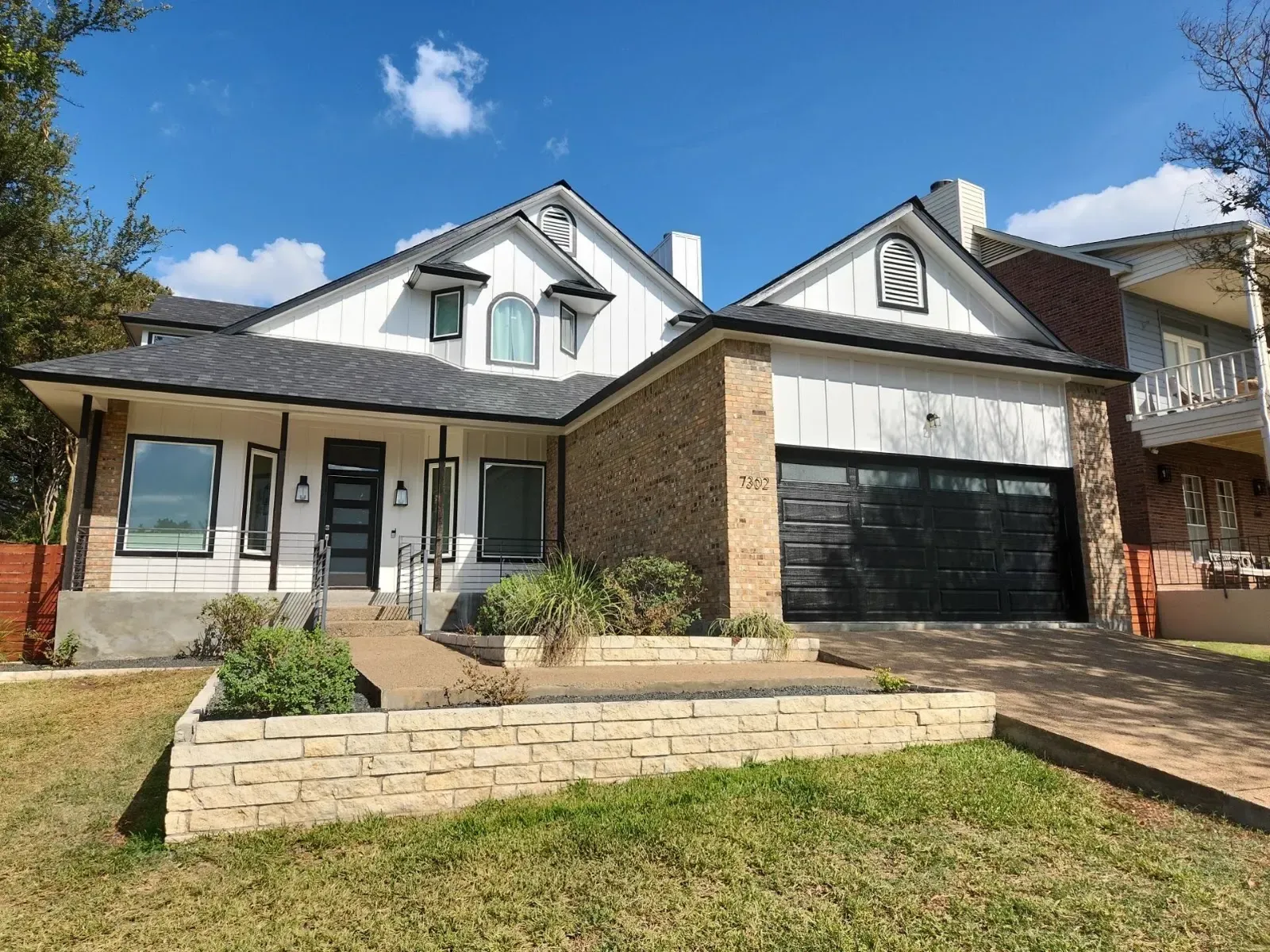 Home exterior with freshly repaired trim and black fascia boards along the roofline