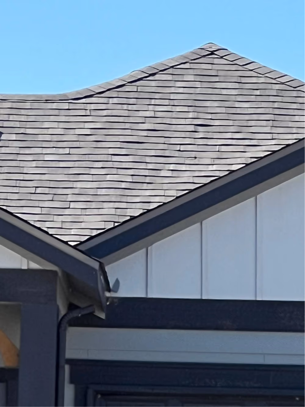 Gray shingles, roof edges and a gutter on a home