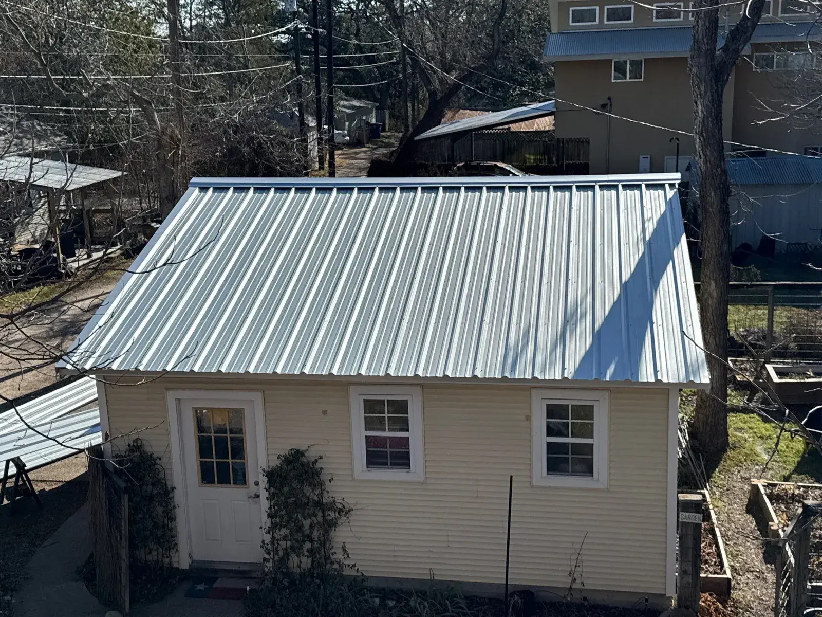 Cool metal roof installation showcasing R-Panel exposed-fastener corrugated steel design