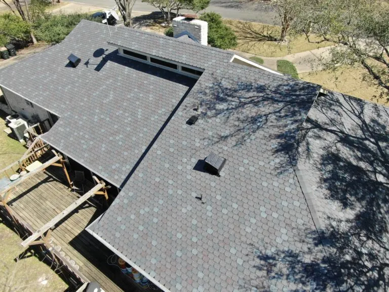 Aerial view of a Central Texas home with new shingles and clean vents