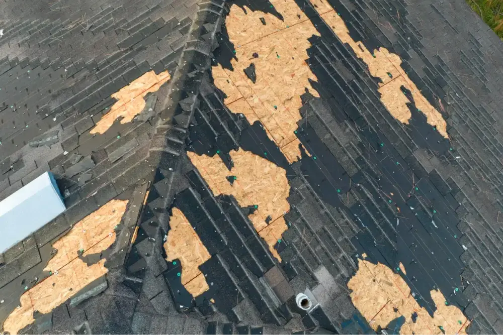 Old asphalt shingles stripped down to the roof decking