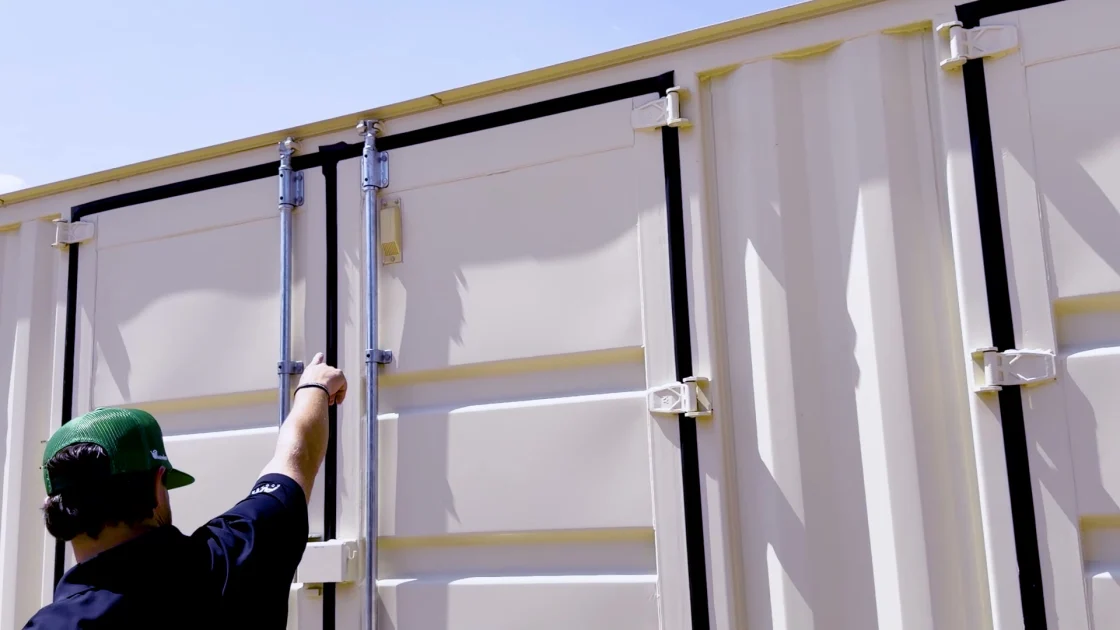 Luke Secora pointing to an intake vent that supplies replacement air for a powered exhaust fan