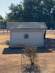 Exposed fiberglass shining through shingles