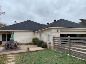 House with black roof and patio