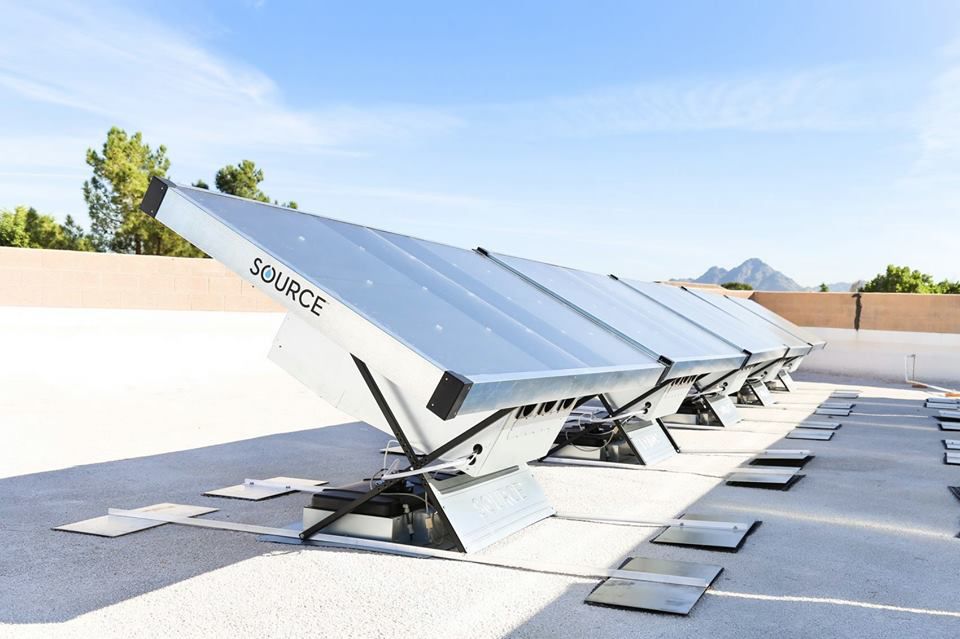 Solar panels on flat roof with clear sky.