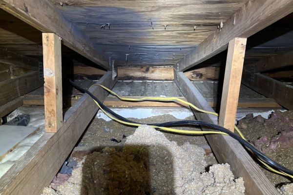Attic space with electrical wiring.