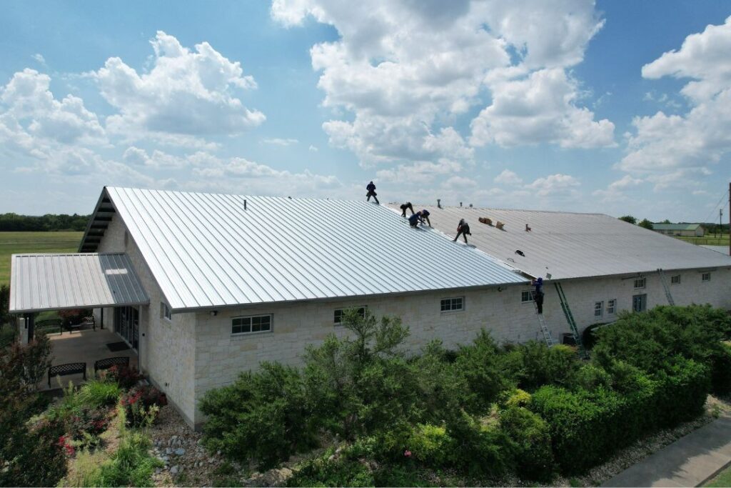 Workers installing a metal roof.