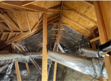 Roof installation on a large metal-roofed building.