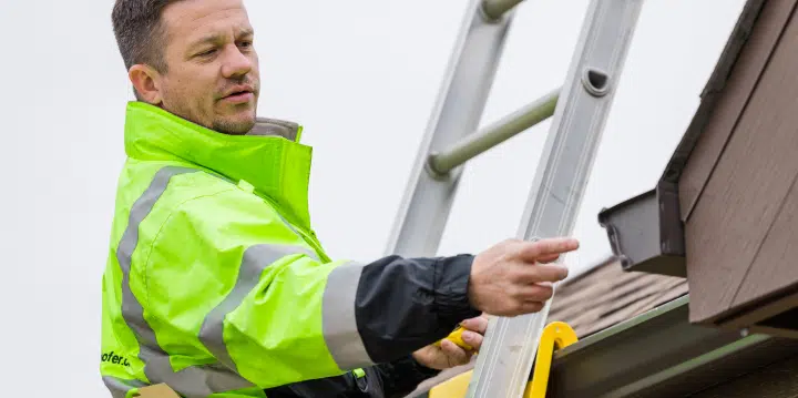 Arkroofr worker on a ladder