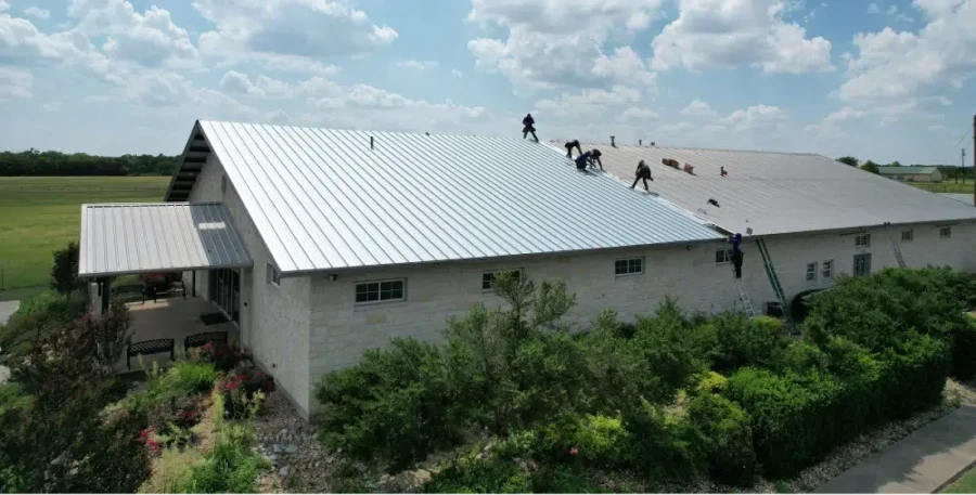 Large metal roof installation in progress.