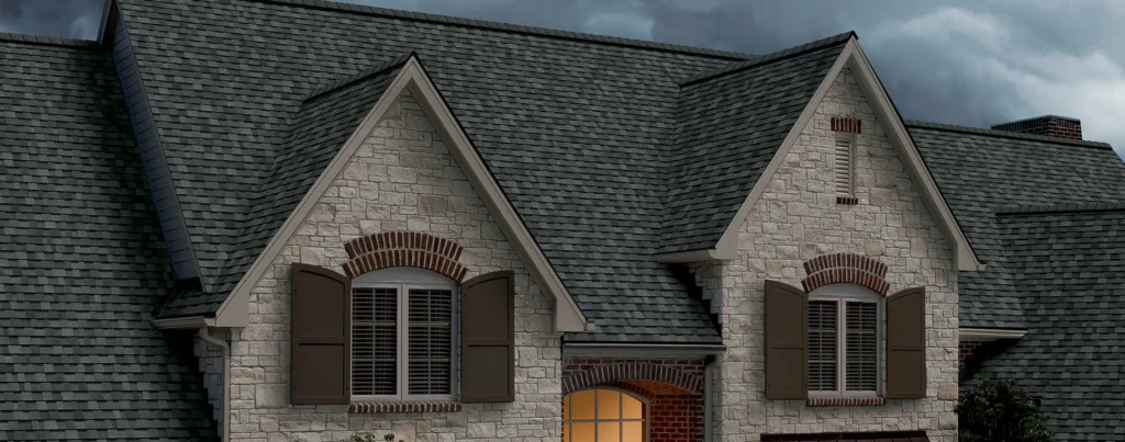 Close-up of a stone house with a gabled roof.