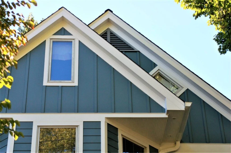 Blue house with white trim and a sloped roof