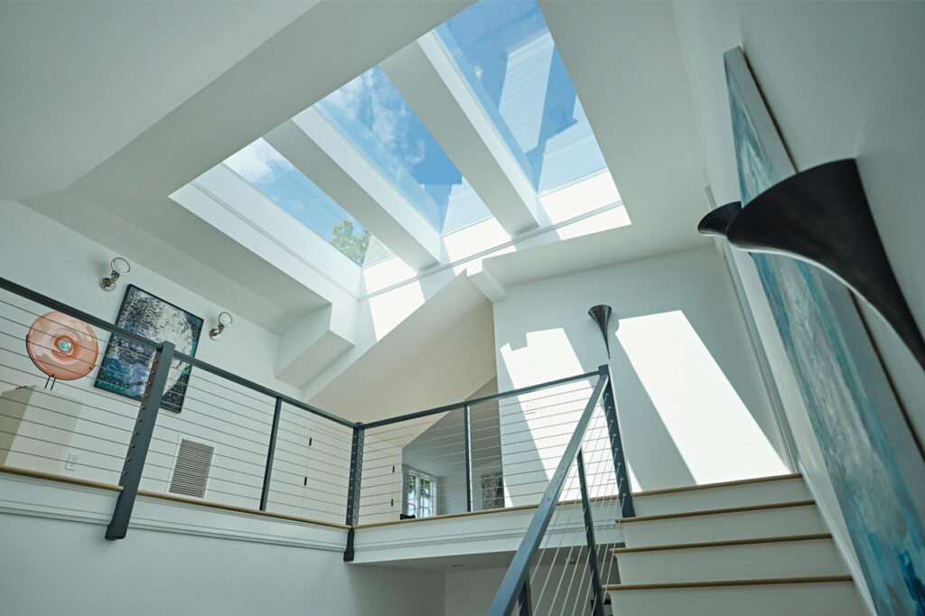 Inside of a house with suns shine coming through the window on the roof