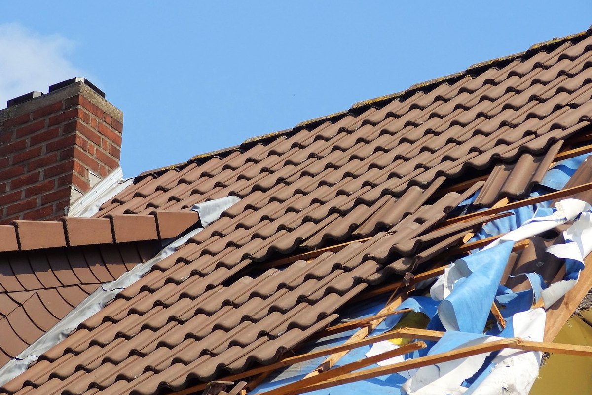 Broken roof tiles with tarp.