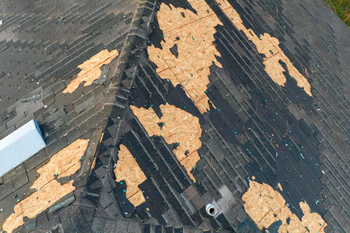 Roof missing large sections of shingles.