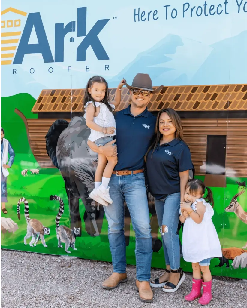 Family standing in front of Ark Roofer truck.