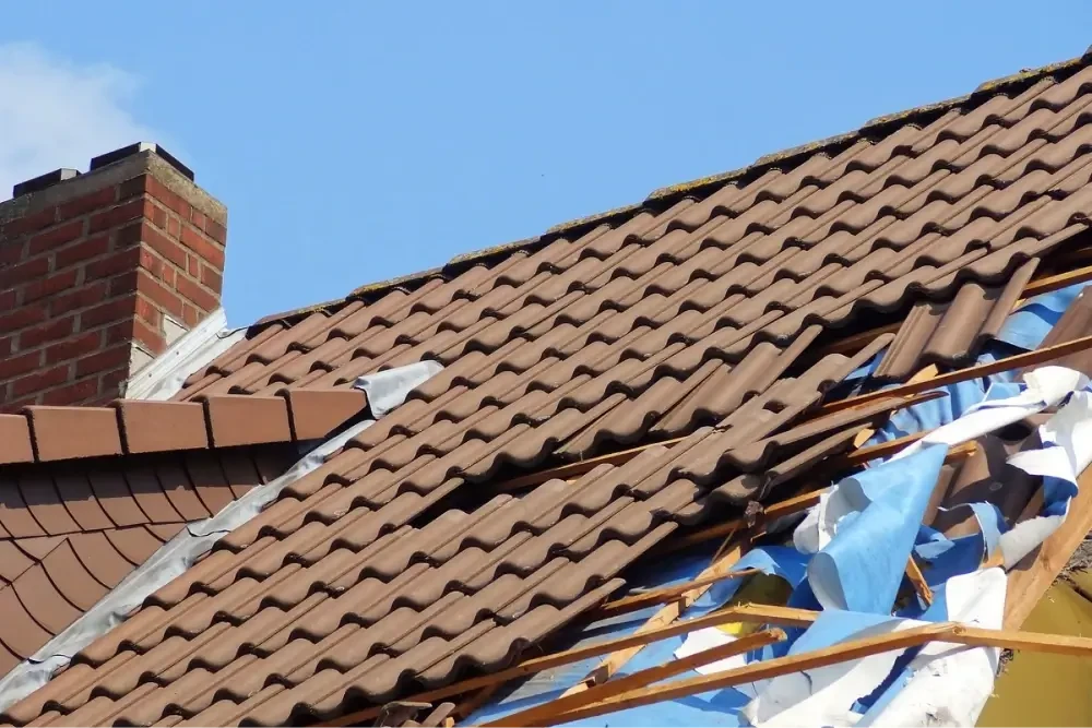 Broken roof tiles with tarp.