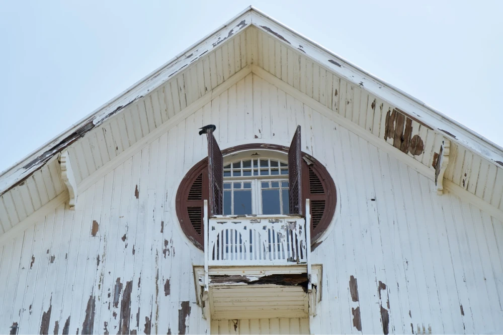 Weathered white wooden house exterior.