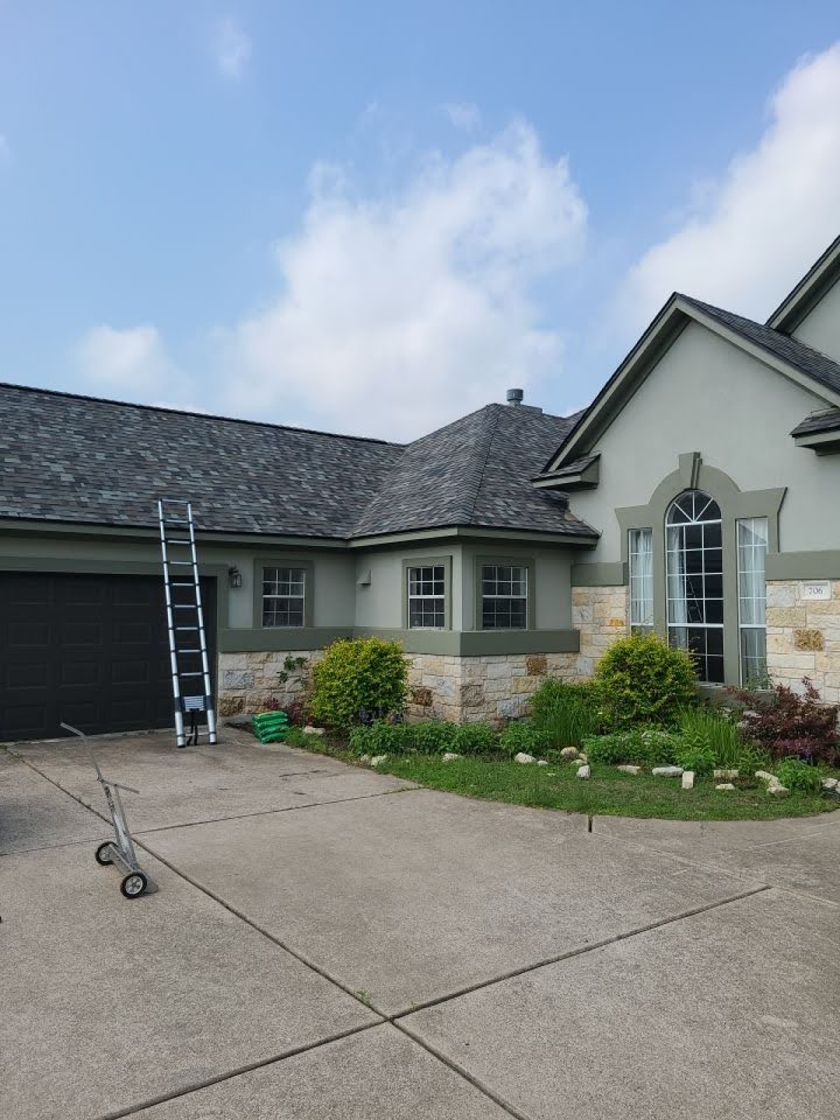 House with a freshly painted exterior and a maintained garden in front.