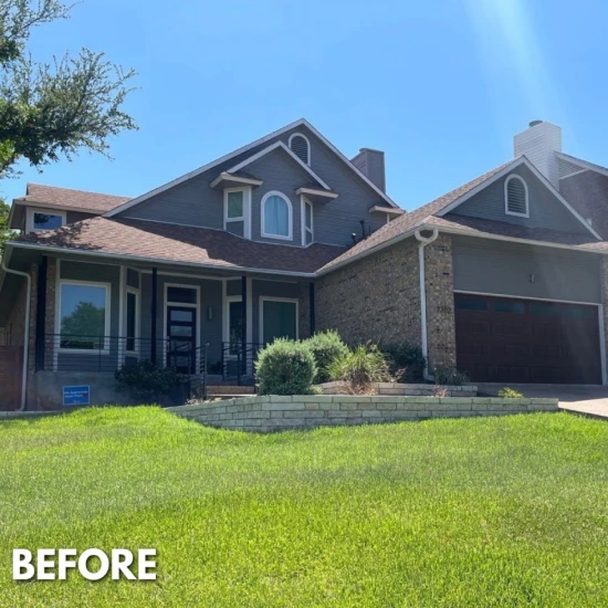 A "before" image of a house with gray siding, brown roof, and minimal landscaping.