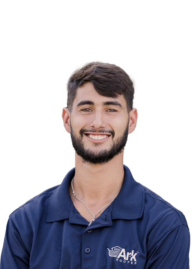 Smiling man with short hair and a beard, wearing a navy blue polo shirt with 'Ark Roofer' logo