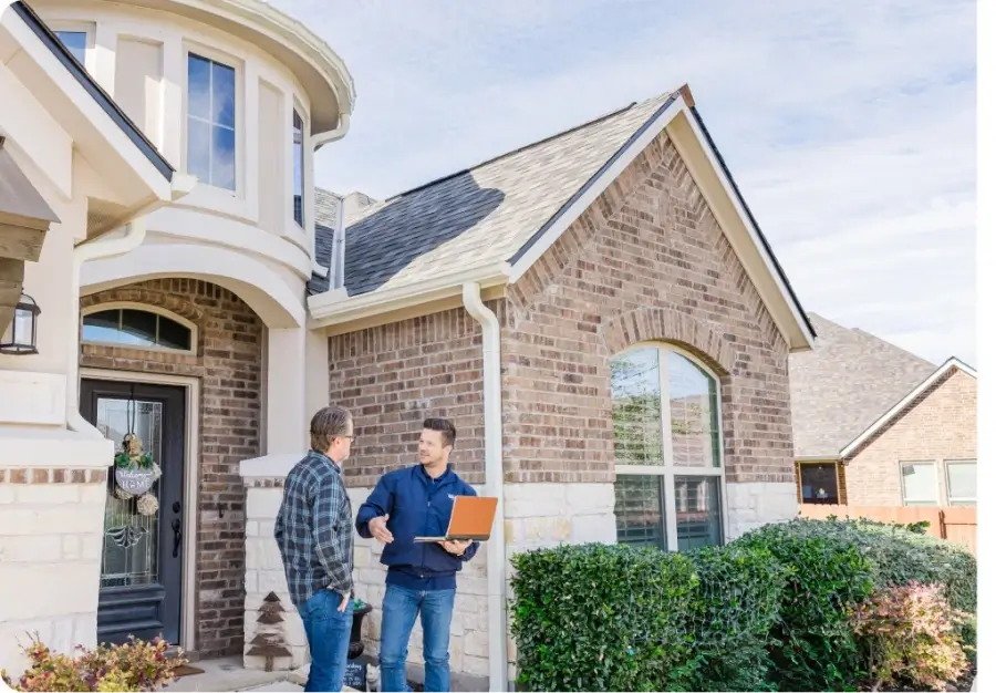 Homeowner and roofer discussing roof inspection.